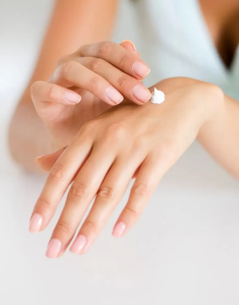 woman-applying-lotion-on-hand-286951